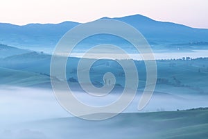 Beautiful colors of green spring panorama landscape of Tuscany. Most popular place in Italy. Green fields and blue sky and Cypress