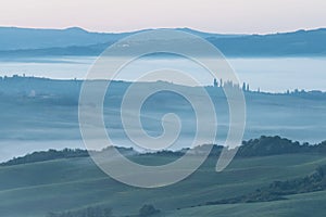 Beautiful colors of green spring panorama landscape of Tuscany. Most popular place in Italy. Green fields and blue sky and Cypress