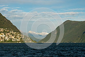 Lugano, Switzerland - October 6th 2021: Lago di Lugano with surrounding hills and mountains in the afternoon sunlight. photo