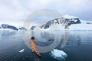 Beautiful colourful kayaks on the blue ocean, Antarctic Peninsula