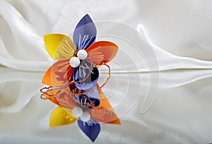 Beautiful colourful origami flower on white background