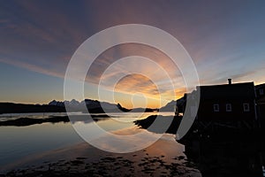 Beautiful and colourful sunrise and morning light over Norwegian fisherman\'s hut in Lofoten, Norway