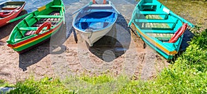 Beautiful colourful wooden boats at lake shore