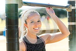 Beautiful commercial athletic model active lifestyle portrait at outdoor city gym fitness and exercise station