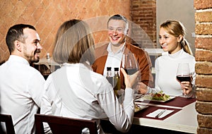 Company of friends eating delicious dinner