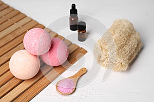 Beautiful composition with aromatic bath bombs on white wooden table
