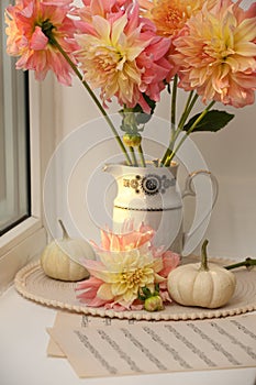 Beautiful composition with dahlia flowers on windowsill. Autumn atmosphere