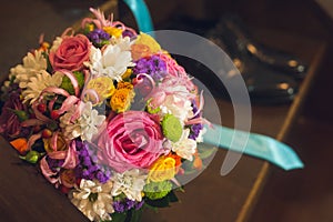 Beautiful composition with a flower bouquet and wedding shoes photo