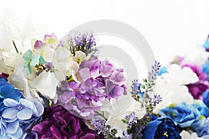 A beautiful composition of fresh purple, violet, pink, blue and white spring flowers on a light background with a copy space