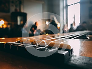 Beautiful composition of interior of a cozy cafe with people inside and guitar bridge