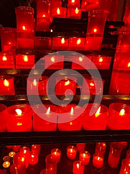 Beautiful composition with red candles burning on black supports. Day of the dead