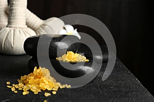 Beautiful composition with spa stones and bath salt on table