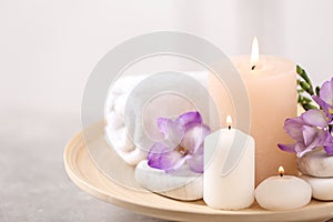 Beautiful composition with spa stones and burning candles on table
