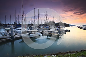 Beautiful composition view of Malaysian Harbour with a yatch during sunset