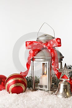 Beautiful composition with vintage Christmas lantern and festive decorations on snow against white background