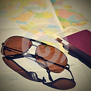 Beautiful concept for summer travel. Sunglasses with passport. Planning a summer vacation and holidays.