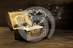 Beautiful concept of vintage chest with light heart miracle on w