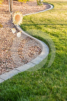 Beautiful Concrete Coping Along Lush Green Grass in Yard.