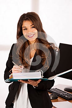 Beautiful confident business woamn holding a folder in her hands