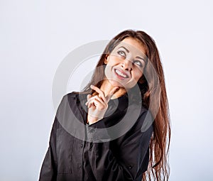 Beautiful confident calm thinking smiling business woman standing and looking in black cotton style shirt on blue light background