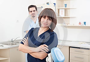 Beautiful and confident dentist woman and male assistant