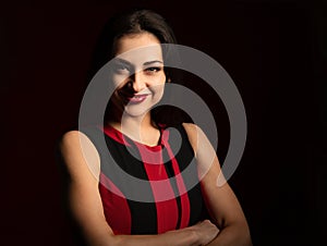 Beautiful confident happy smiling business woman with folded hands on red background with empty copy space. Closeup portrait of