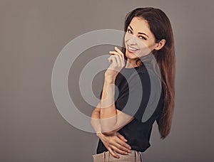 Beautiful confident laughing thinking smiling business woman have an idea in black t-shirt on grey background with empty copy