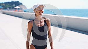 Beautiful confident shapely woman in black swimwear