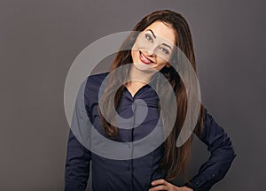Beautiful confident thinking smiling business woman with folded arms looking front in blue shirt on grey background with empty