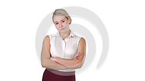 Beautiful confident young businesswoman standing with hands folded on white background.