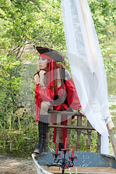 Beautiful Contemplating Pirate Woman on Small Boat with Pirate Hat