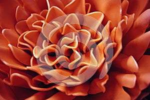 Beautiful coral flower made of synthetic material . Abstract blurred background.