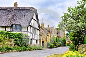 Beautiful Cotswolds village with half timbered thatched roof house, England