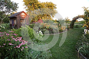 Beautiful Cottage Garden Shed with Landscaped Grass Yard and Flowers
