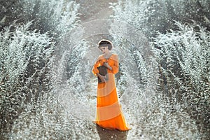 The beautiful countess in a long orange dress