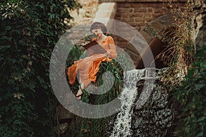 The beautiful countess in a long orange dress photo
