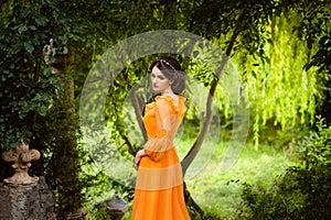 The beautiful countess in a long orange dress photo