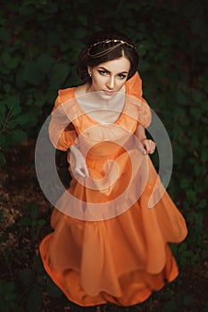 The beautiful countess in a long orange dress photo
