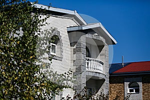 Beautiful country house behind a high fence. Chic cottage in a holiday village.