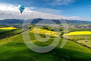 Beautiful country landscape with green, yellow fields and Low Tatras mountains at backgorund