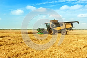 Beautiful countryside landscape .Combine harvester on a wheat field