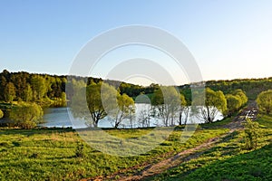 Beautiful countryside landscape. Green meadow and river in the evening. Summer. Russia