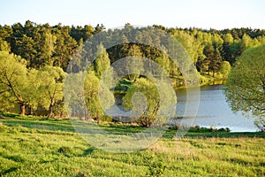 Beautiful countryside landscape. Green meadow and river in the evening. Summer. Russia