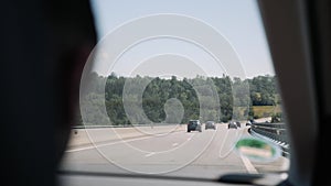 Beautiful countryside landscape with highway with a view through the windshield. Car driving on speedway with view from passenger