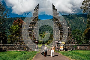 Beautiful couple at the Bali temple. Man and woman traveling in Indonesia. Couple at the Bali gate. The couple travels the world