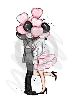 Beautiful couple with balloons in the shape of hearts. A girl in a dress and high-heeled shoes and a man in a coat and trousers.