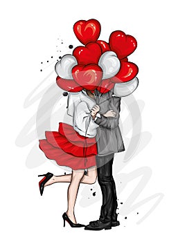 Beautiful couple with balloons in the shape of hearts. A girl in a dress and high-heeled shoes and a man in a coat and trousers.