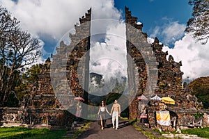 Beautiful couple at the Baltic temple. Man and woman traveling in Indonesia. Couple at the Bali gate.