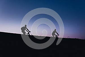 Beautiful Couple on bicycles silhouette sunset two bike ride