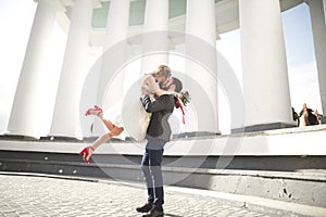 Beautiful couple, bride and groom posing near big white column